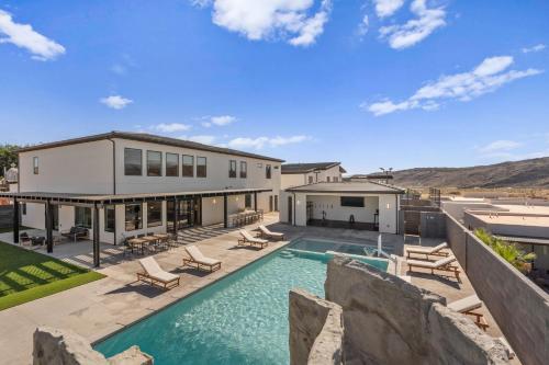 an exterior view of a house with a swimming pool at Pecan Valley Oasis - Lux Pool, Sauna and Theater in Hurricane