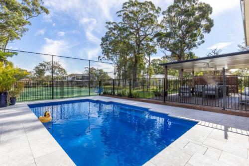 a swimming pool in the backyard of a house at Anglesey - Pet Friendly with Pool - 4 Mins Walk to Beach in Callala Bay