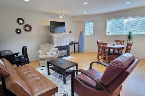 a living room with a couch and a table at Cheerful 2BR suite, onsite free parking CARS or RV in North Vancouver