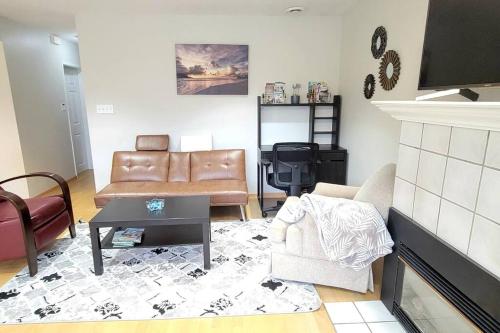 a living room with a couch and a fireplace at Cheerful 2BR suite, onsite free parking CARS or RV in North Vancouver