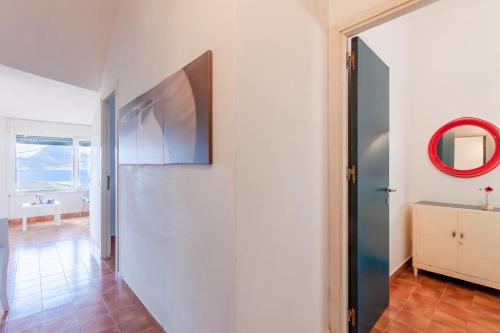 a hallway with a sliding door and a mirror at Villa Macari Fantastic Sea View - Happy Rentals in Macari