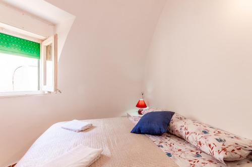 a bedroom with a bed with a pillow and a window at Villa Macari Fantastic Sea View - Happy Rentals in Macari