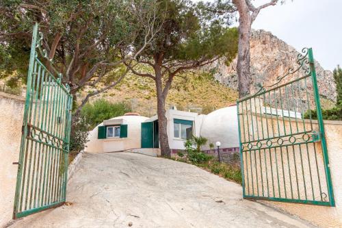 a gate to a driveway with trees and houses at Villa Macari Fantastic Sea View - Happy Rentals in Macari