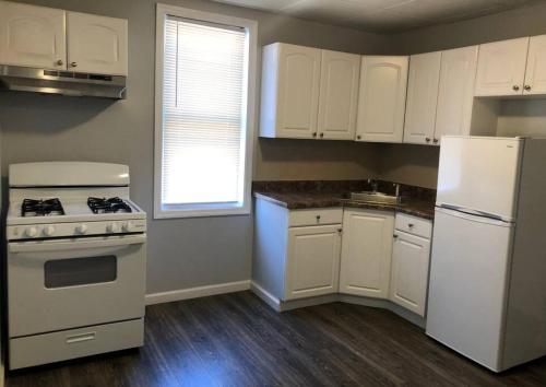 a kitchen with white appliances and a white refrigerator at Private 2-bedroom with free parking and direct bus to NYC Manhattan only 2 blocks away in Linden