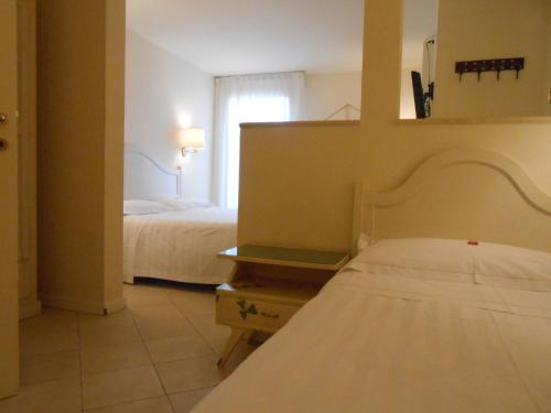 a hotel room with a bed and a window at Hotel Atlantic in Bologna