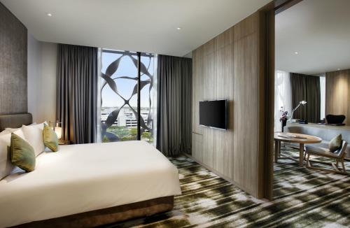a hotel room with a bed and a desk at Crowne Plaza Changi Airport by IHG in Singapore