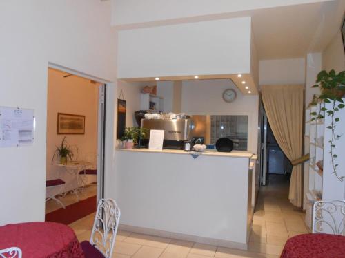 a kitchen and a living room with a counter at Hotel Atlantic in Bologna