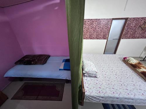 a bedroom with a bunk bed with purple walls at Orchid Park Homestay in Sivasagar