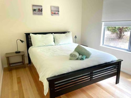a bedroom with a large bed with two teddy bears on it at Dune Escape - beach tranquility in Emu Bay