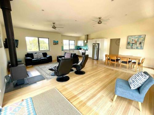 a living room with a couch and chairs and a table at Dune Escape - beach tranquility in Emu Bay