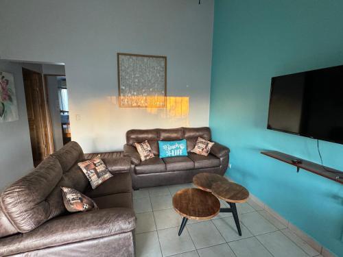 a living room with a couch and a table at Happy Oasis Second Floor Condo With Terrace in Coco