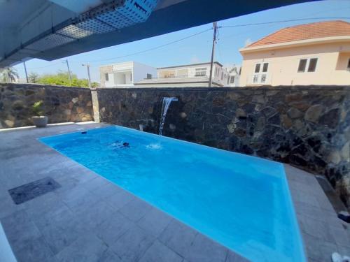a swimming pool in the backyard of a house at Seaside Escape Apartment in Flic-en-Flac
