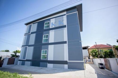 a blue and white building with a sign on it at K&K Apartment in Bang Phli