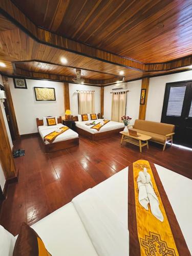 Luang Prabang Oudomlith Villa & Travelにあるベッド