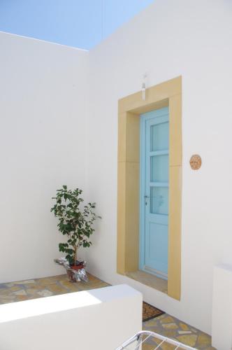 a blue door in a white room with a potted plant at Villa Patmos Netia in Patmos
