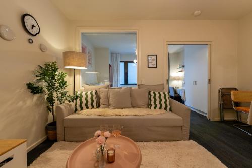 a living room with a couch and a table at Shopping spot-Emporium-Melbourne Central Deluxe Emporium suite in Melbourne