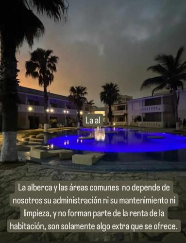 a pool with blue lighting in front of a building at CARASOL VILLAS y SUITES PRIVADAS in Ciudad Madero