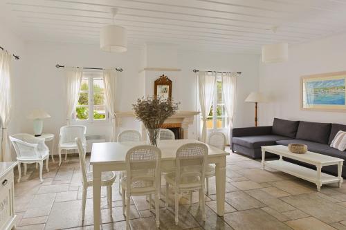 a living room with a table and a couch at Villa Nika in Spetses