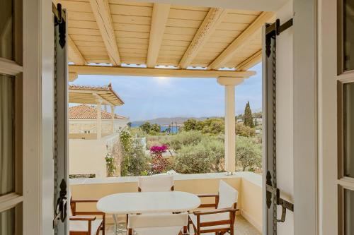 a view from the balcony of a house with a table and chairs at Villa Nika in Spetses
