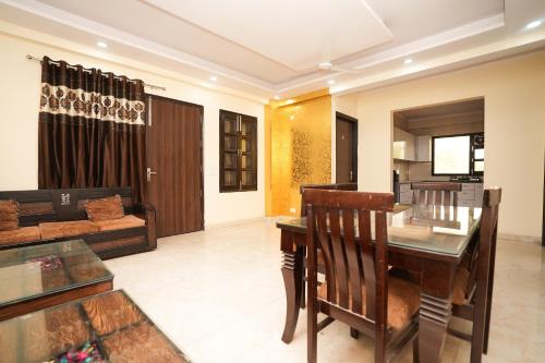 a living room with a table and a couch at Prince Villa in Gurgaon