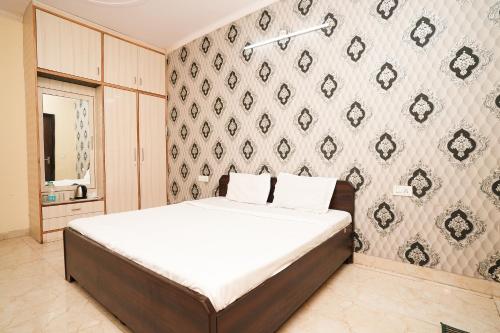 a bedroom with a bed and a wall at Prince Villa in Gurgaon