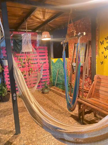 a room with a hammock and a wooden bench at Hostal el Alebrije in Valle de Bravo