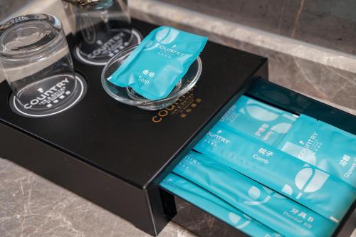 a black box with two glasses and a bottle at Country Inn & Suite by Radisson, Guangzhou Huadu Shiling in Huadu