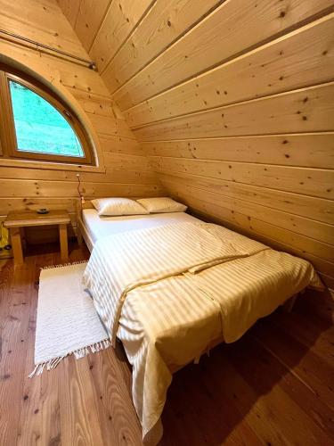 a bedroom with two beds in a log cabin at Drewniana Oaza in Ochotnica Dolna