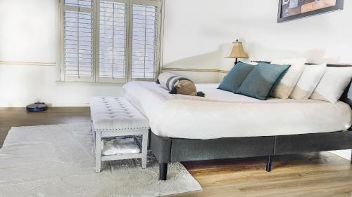 a large white couch in a living room with a stool at Casa Grande Luxur in Overland Park