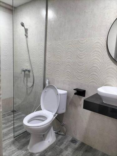 a bathroom with a toilet and a shower and a sink at nice apartment with city view at Grand Jati Junction in Medan