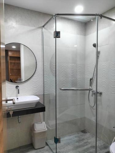 a bathroom with a glass shower and a sink at nice apartment with city view at Grand Jati Junction in Medan