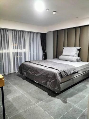 a bedroom with a large bed in a room at nice apartment with city view at Grand Jati Junction in Medan