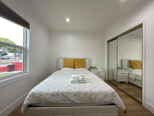 a white bedroom with a bed and a large window at Elegant Living Private Room in Modern Home 9 in Los Angeles