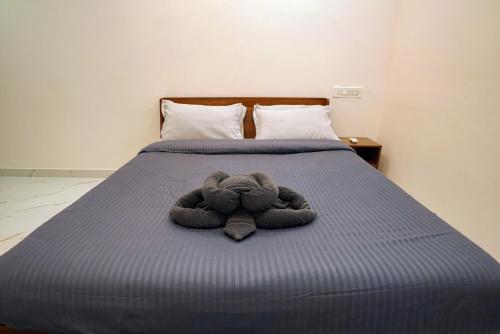 a stuffed animal is laying on a bed at N Cube Serviced Apartments in Hyderabad