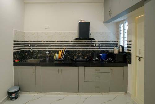 a kitchen with a sink and a counter top at N Cube Serviced Apartments in Hyderabad