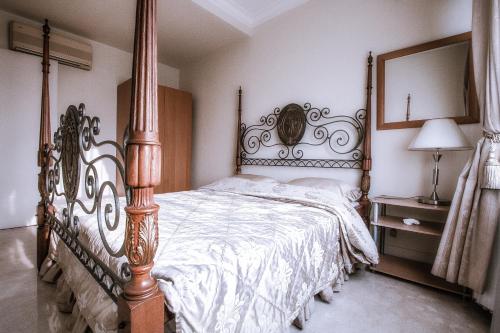 a bedroom with a large bed with a wooden frame at Batavia Apartment ST in Jakarta
