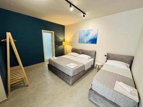 a bedroom with two beds and a ladder in it at STAY-FIVE rooms & apartments in Shkodër