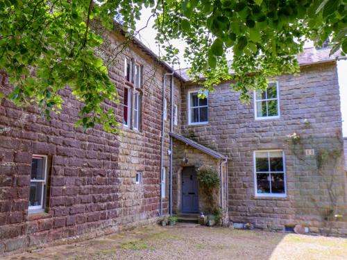 an old brick building with a blue door at The Grange in Whitby