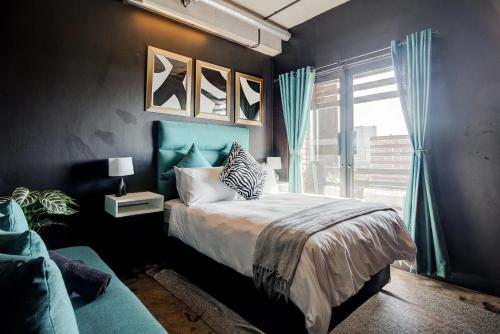 a bedroom with a bed and a window at Premium Stay in Central Johannesburg Cultural Heart - Hallmark House in Johannesburg