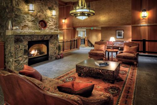 a living room filled with furniture and a fire place at The Steamboat Grand in Steamboat Springs