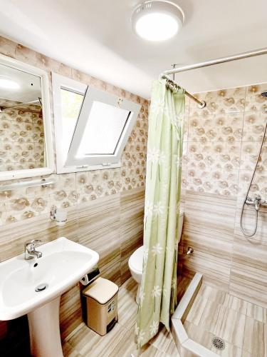 a bathroom with a sink and a toilet at Garden Rooms in Himare