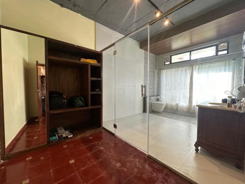 a bathroom with a glass shower and a sink at The Windchimes Retreat Coorg in Virajpet