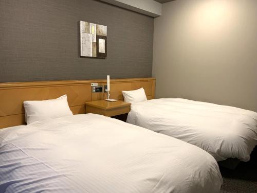 Voodi või voodid majutusasutuse Hotel Route-Inn Shiojirikita Inter toas