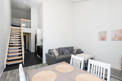 a living room with a couch and a table at Hilmantori Apartments by Hiekka Booking in Kalajoki