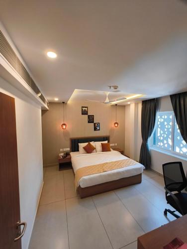 a bedroom with a bed and a desk and a window at HOTEL CHALLIYIL CASTLE in Shertallai