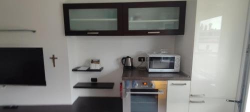 a small kitchen with a microwave and a counter top at Shangri-la in Civate