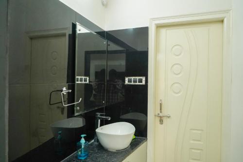 a bathroom with a sink and a mirror at N Cube Serviced Apartments in Hyderabad
