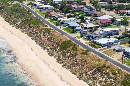 an aerial view of a beach with houses and a road at Relaxing Getaway Beachfront Access Multi Family Pets Mandurah in Mandurah