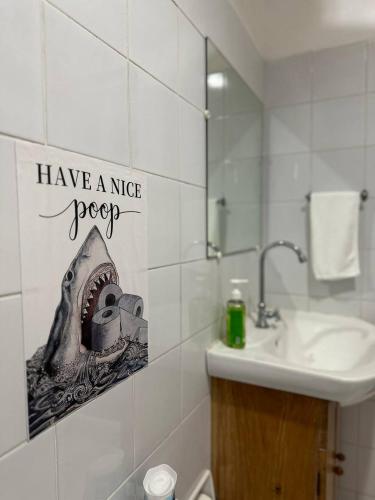 a bathroom with a sign that says have a nice spear at VitaminSea Room in Dauin