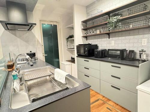 a kitchen with a sink and a counter at Akikawa Koshi 6 in Kikutomi